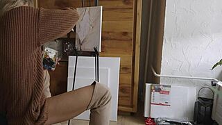 Blonde babe in boots paints her pretty pussy like a flower