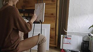 Blonde babe in boots paints her pretty pussy like a flower