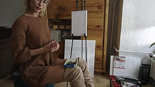 Blonde babe in boots paints her pretty pussy like a flower