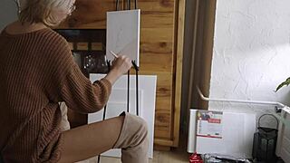 Blonde babe in boots paints her pretty pussy like a flower