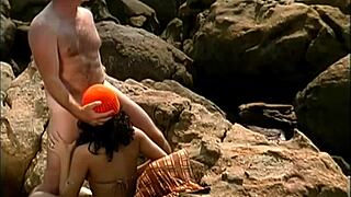 Mature Man Pounds Exotic Babe's Clit and Pussy on Seaside Stones Cowgirl Style