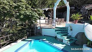 tattooed latina plays around by the pool outdoors