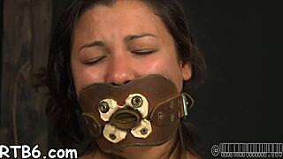 Bound contestant in sadomasochism harness endures rough licking and fucking competition