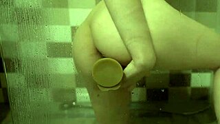 Whoa catch those big boobs shaking as she fucks dildo in shower