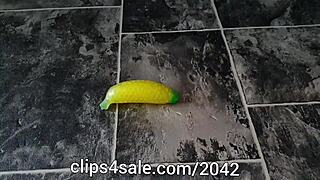 Barefoot femdom tramples banana toy in domination foot fetish play