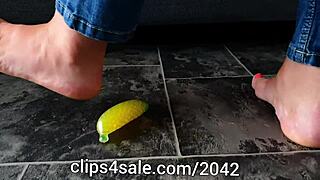 Barefoot femdom tramples banana toy in domination foot fetish play