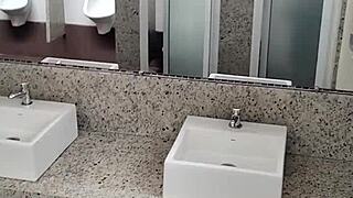 Guy masturbates with handjob in public bathroom toilet