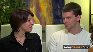 A swinger couple explores each other's bodies intimately during casting