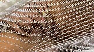 Brunette milf in fishnets spreads legs teases pussy closeup solo