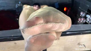 mistress's sexy nyloned feet tease closeup on desk