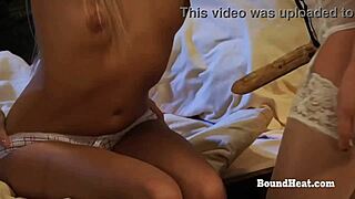 lesbian mistress rams strapon deep into bound slave's pussy while she squirms