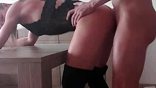 she's bent over desk in boots taking cumshot doggystyle.