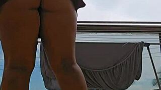 check out this naughty maid flashing her big ass from the balcony