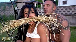 Colombian tourist Mariana Martix bends for Italian farmer Luca Peracchi's tractor cock
